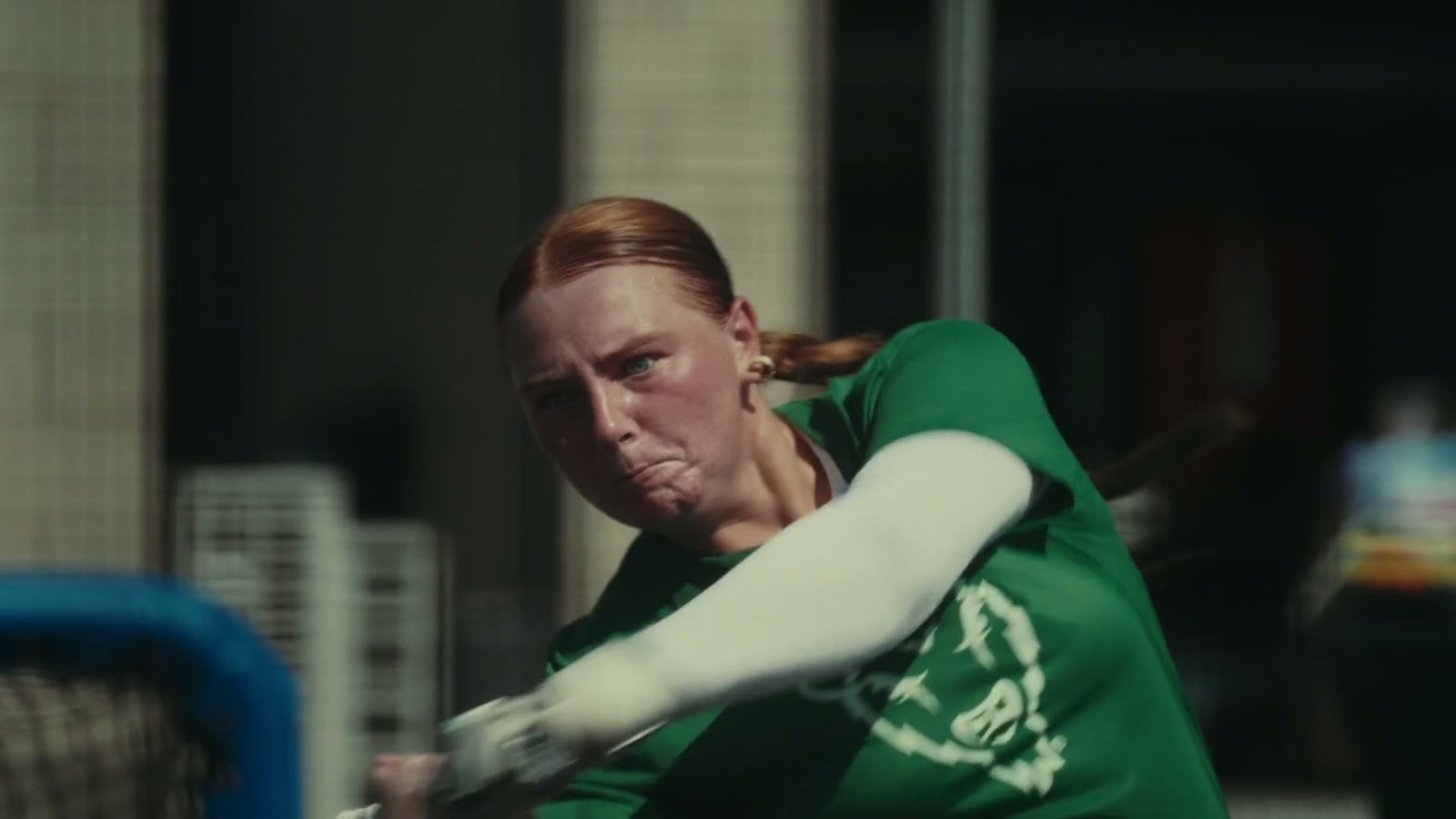 Softball athlete swinging a bat